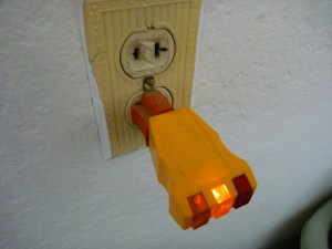 The three prong adapter is screwed into a box that is not grounded.  This is not a safe ground